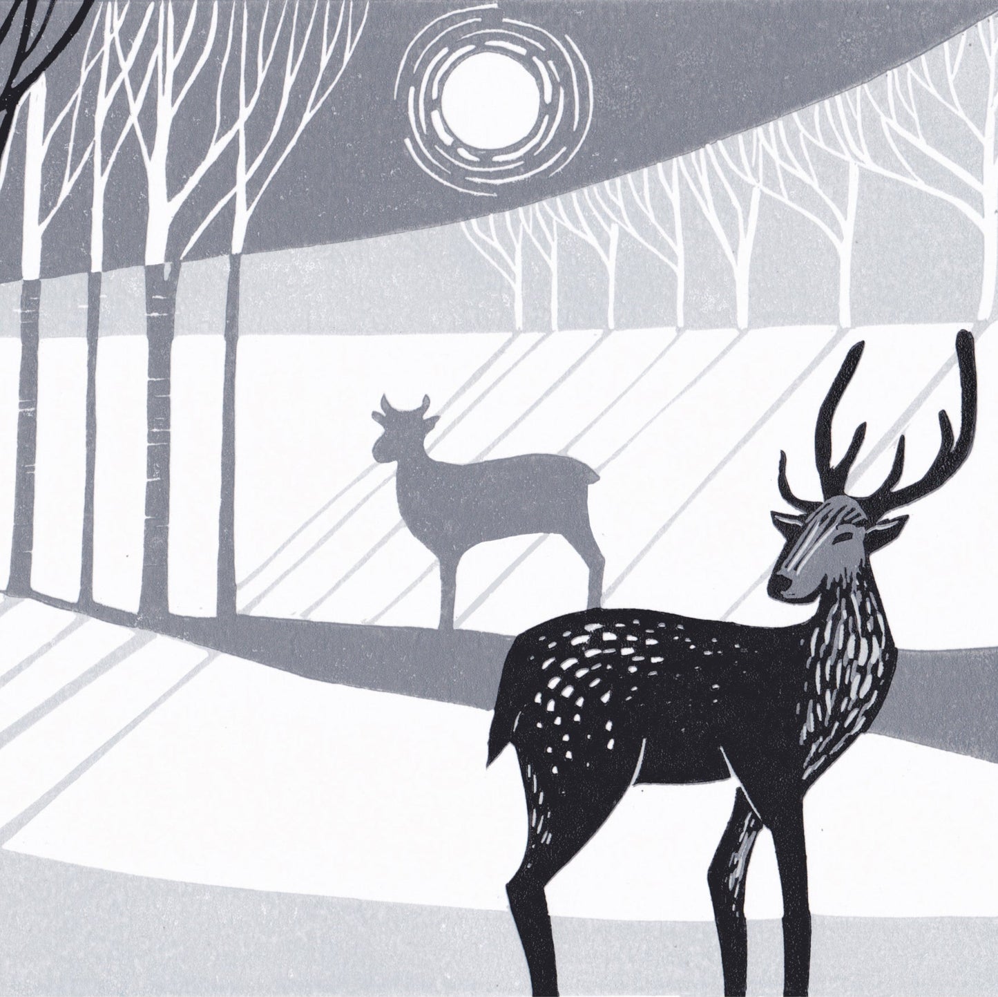 A lino print featuring two stylized deer in a woodland setting with moonlight.
