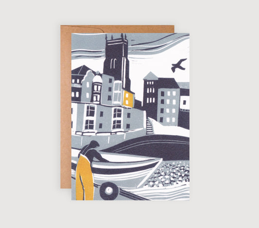 A greetings card featuring a linocut print of a fisherman on the slipway at Cromer, with the town's buildings in the background. The card is A6 size and comes with an envelope.