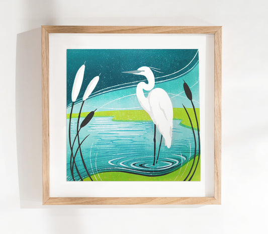 An original lino print of an egret in the reeds in blue and green colours.