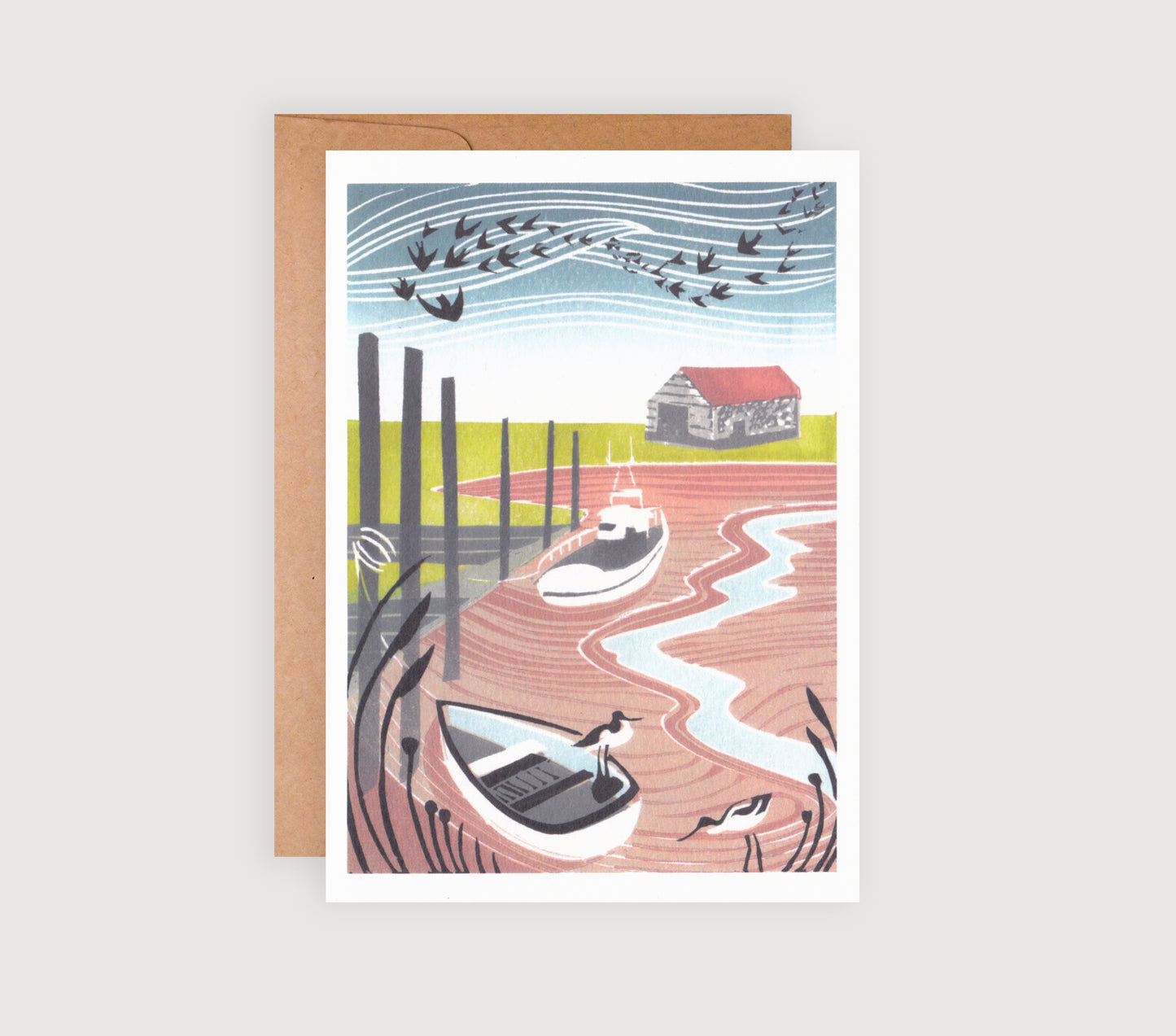 A greetings card featuring a linocut print with two avocets in the foreground and a Norfolk coastal scene in the background.