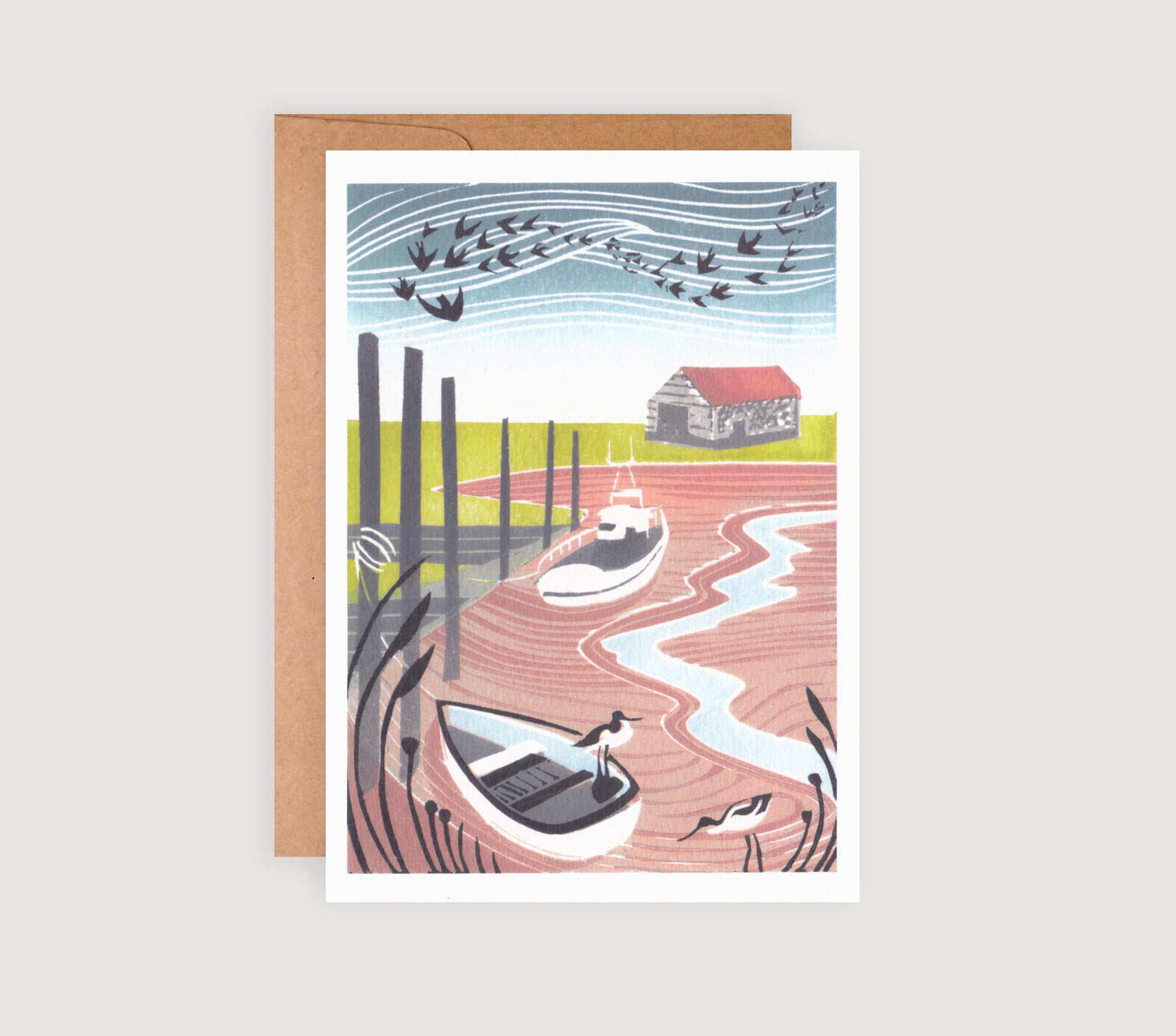 A greetings card featuring a linocut print with two avocets in the foreground and a Norfolk coastal scene in the background.