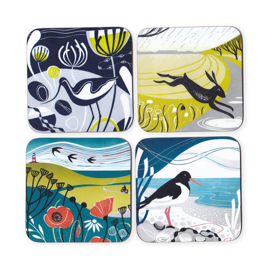 A set of four round coasters with lino print designs featuring coastal and marine life themes.