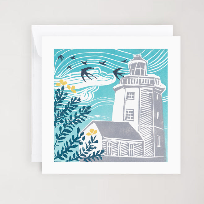 A greetings card featuring an illustration of Cromer Lighthouse surrounded by floral elements and birds in flight, against a blue background. The card is square and comes with a white envelope.