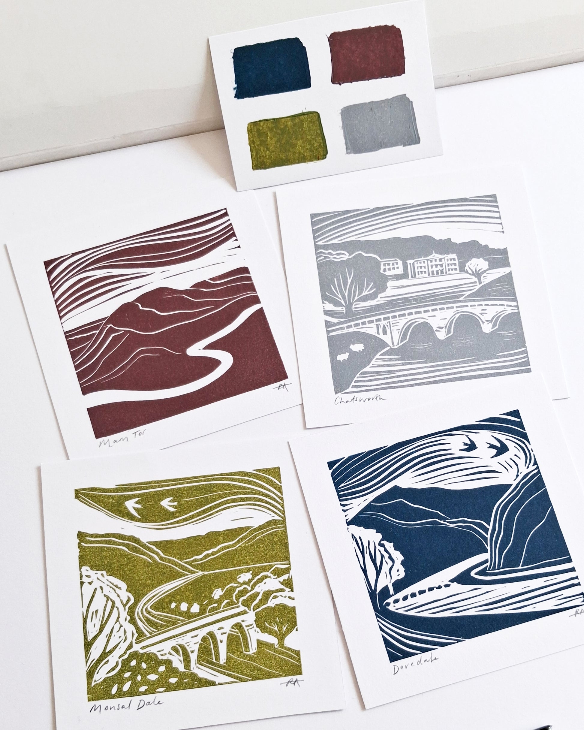 Set of four landscape prints with color swatches on a white background