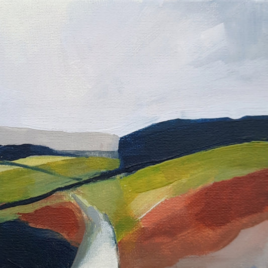 A canvas painting featuring a landscape with green, yellow, and red fields and a grey sky.