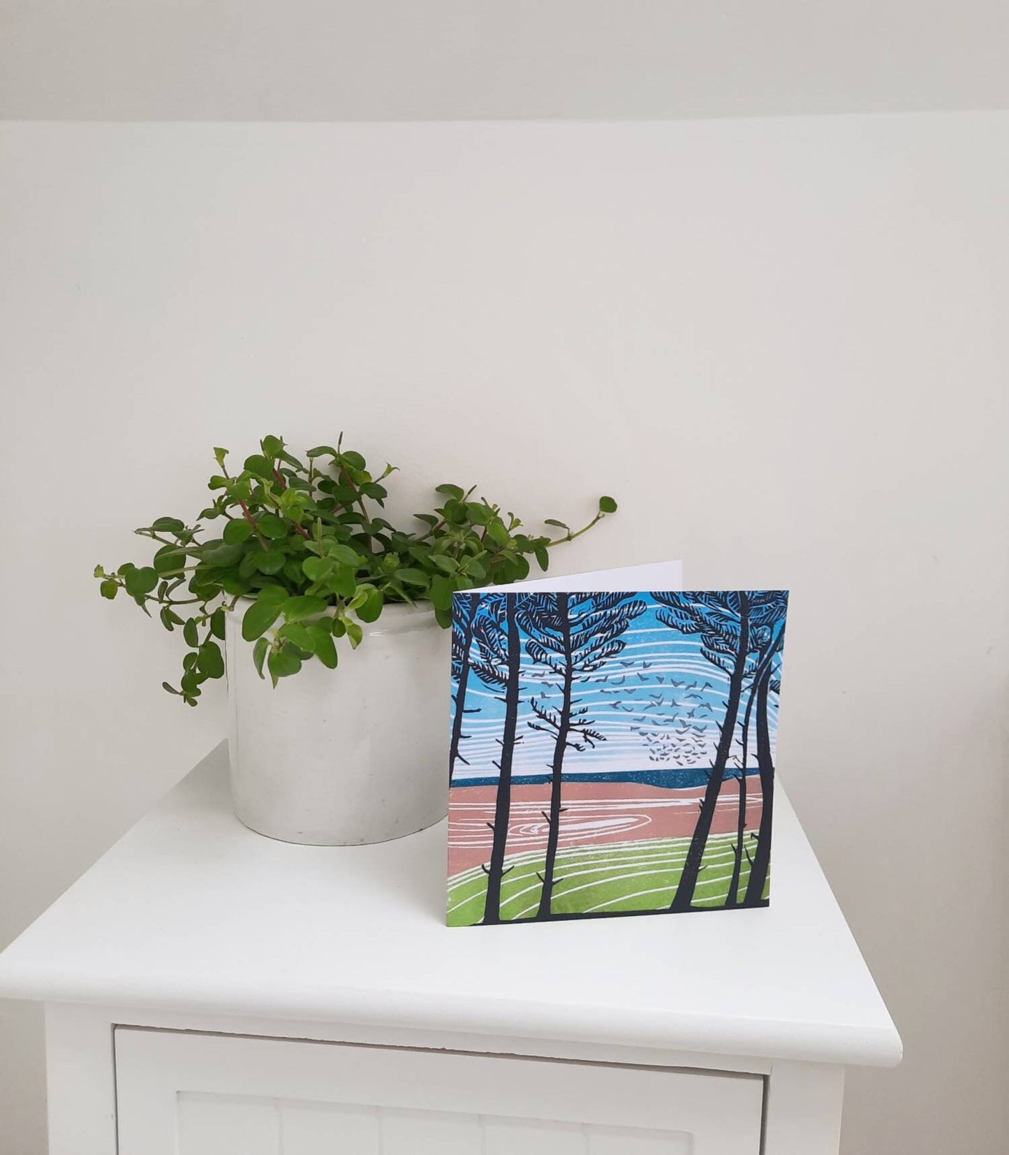 greetings card depicting Holkham in Norfolk looking through the pine trees towards the beach.