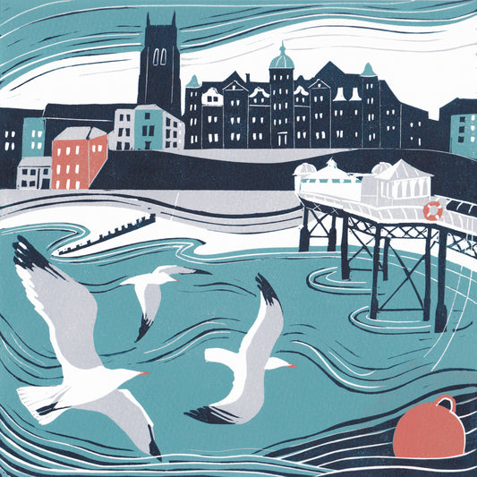 Original lino print of Cromer on the Norfolk coast, featuring the pier, seagulls and the seafront buildings.