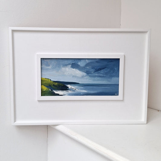 Original framed landscape painting of waves crashing against rugged cliffs